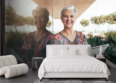 Portrait of a beautiful grey haired middle aged smiling woman working with tablet looking into the camera Wall mural