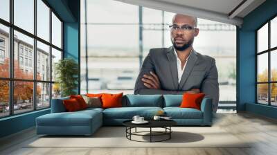 Portrait of a confident black businessman holding with his arms crossed Wall mural