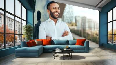 Portrait of a young confident smiling indian man with his arms crossed looking into the distance Wall mural