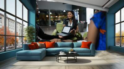 Smiling group of diverse businesspeople having an office meeting in open plan office space Wall mural