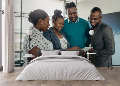 Team of african business people standing and smiling using a tablet Wall mural