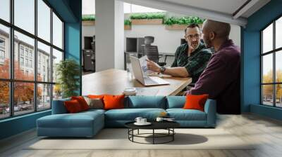 To diverse businessmen working together at an office table Wall mural