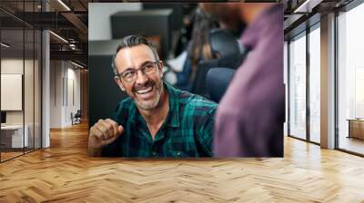 well dressed handsome caucasian creative entrepreneur smiling and talking to african coworker Wall mural