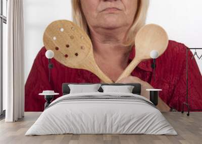 Elderly blond woman with wooden spoons Wall mural