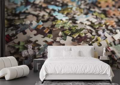 Jigsaw puzzle. Pile of jigsaw puzzle peices. Conceptual photo with focus on undone puzzle Wall mural