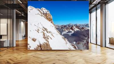 The great view of the Titlis: The rugged beauty of the Swiss Alps shines in a majestic landscape of snow-capped peaks, from the lofty mountain top Wall mural