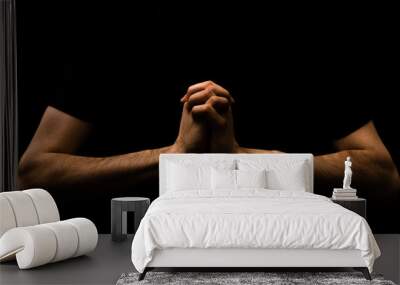 Young Man Praying to the Lord Isolated Black Background Wall mural