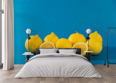 group of yellow lemons (fruit) under a blue background. Wall mural