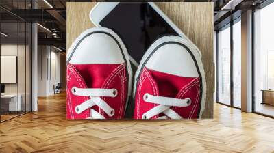 Pair of red sneakers and a smartphone Wall mural