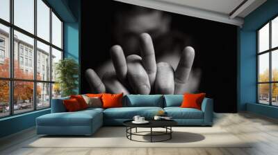 Black and white image of a man and a woman holding hands generating an out of focus background. Close shot of a couple's hands joined leaving their bodies behind with blur. Wall mural