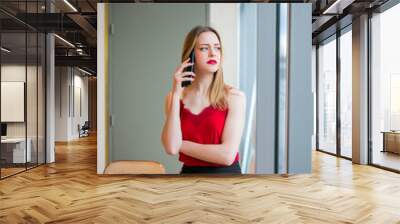 blonde woman sitting in a bar calling her boyfriend Wall mural