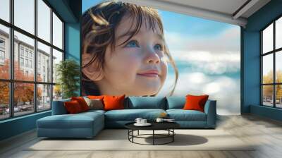 Closeup of cute little girl smiling while looking Wall mural