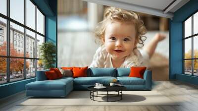 Cute baby girl crawling on hardwood floor at home Wall mural