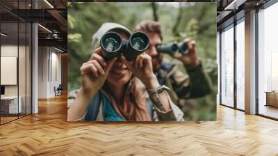 happy couple on vacation in mountains looking with binoculars Wall mural