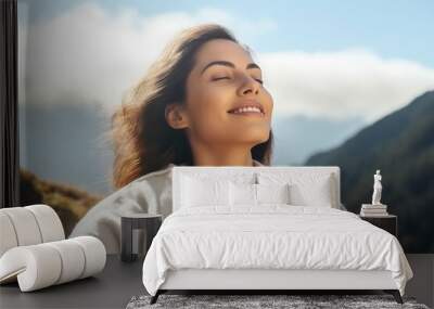 relaxed young woman breathing fresh air in the mountains Wall mural