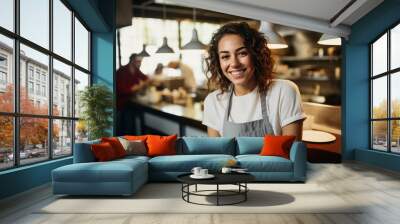 woman smiling posing in front of the camera in a restaurant kitchen Wall mural