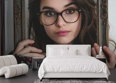 young woman holding a frame isolated on a white background Wall mural