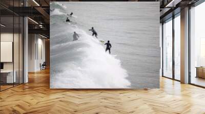 People surfing waves at Great Western Beach in Newquay UK. Wall mural