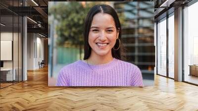 Close up individual portrait of a joyful and adorable teenage hispanic woman with friendly expression. Happy latin young female student looking at camera enjoying smiling with a perfect white teeth Wall mural