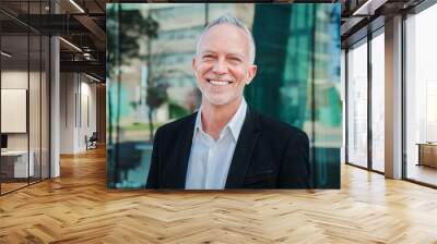 Close up portrait of mature adult business man with gray hair and suit smiling and looking at camera with succesful attitude. Happy corporate lawyer with white perfect teeth standing at workspace Wall mural