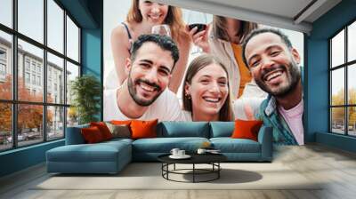 Vertical portrait of a group of young adult multiracial 30s friends having fun on a winery with wine glasses taking a selfie together. Men and women enjoying their friendship on party celebration fest Wall mural