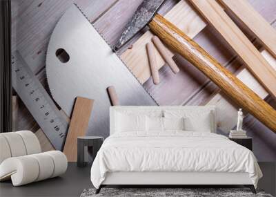 Pieces of wood and tools for construction and repair on a wooden table Wall mural