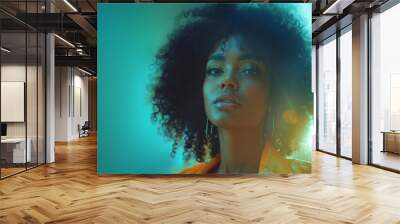 A portrait of an African American woman with afro hair, captured as the golden hues of the setting sun against a soft-focus urban backdrop. Wall mural