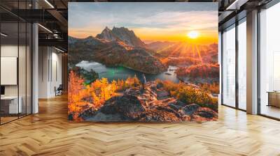 Me standing on a ledge as the sun rises over the Enchantments. Wall mural