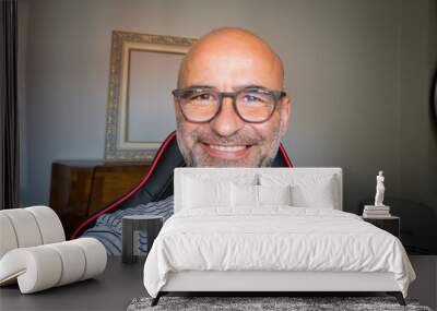 selfy of happy bald man with glasses inside Wall mural