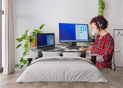 Woman telecommuting at an adjustable standing desk Wall mural