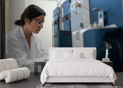 a woman scientist analyzing samples in a laboratory Wall mural