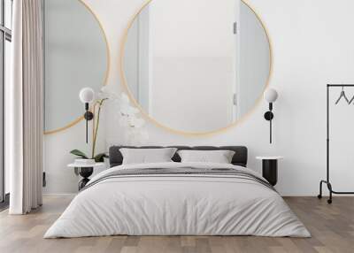 A beautiful bathroom with a wood cabinet, marble countertop, and gold circular mirrors.	
 Wall mural