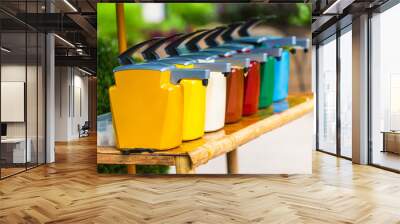 A line of colorful condiment containers/dispensers at an outdoor restaurant. Wall mural