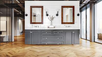 A luxurious renovated bathroom with a grey vanity, rustic wood framed mirrors, and chrome faucets and hardware. Wall mural