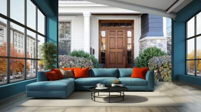 A wooden front door, surrounded by windows, with white, blue, and stone siding. Wall mural