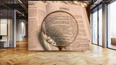 Reading with magnify glass the Bible James 1 Wall mural