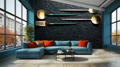 set of pink, green and gold forks and spoons on a black background. Flat and top view. Modern food. Copy Space Wall mural