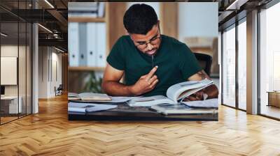 Student, black man and books to study on home desk thinking, reading and studying for college. Person learning and focused on information on page for education, knowledge and working on law research Wall mural