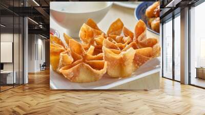 chinese crab rangoon fried wontons on plate with red sauce Wall mural