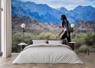 fit african american woman hiking through alabama hills park in california Wall mural