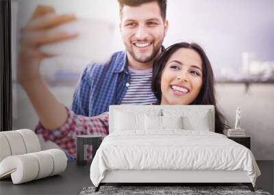 happy couple taking selfie on beach with smartphone Wall mural