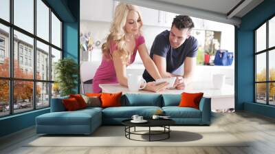 happy couple using tablet pc to shop online or watch videos in kitchen at breakfast Wall mural