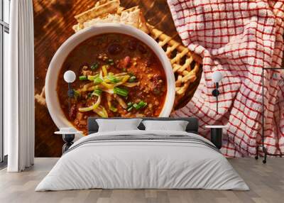 overhead photo of a bowl of chili with cheese and green onions Wall mural