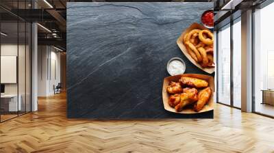 pub appetizers such as chicken wings, onion rings and french fries in panoramic composition Wall mural