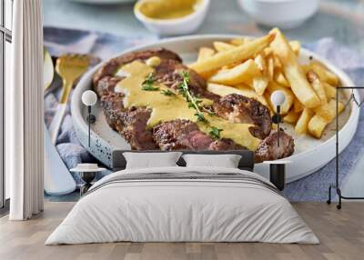 sliced beef steak with sauce and french fries Wall mural