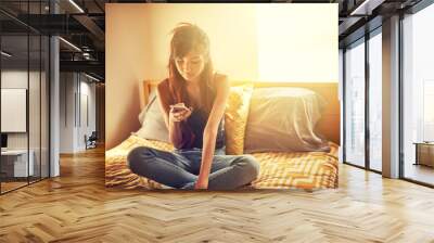 tech savvy asian teen girl using smart phone in bed Wall mural