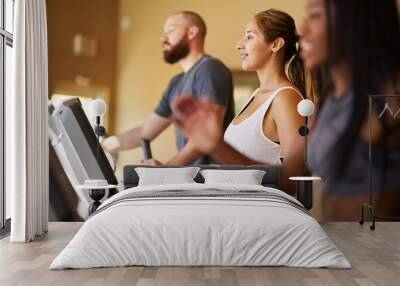 three people using treadmills in gym together Wall mural