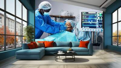 Healthcare, doctor and patient in mask for oxygen in surgery, emergency care and hospital bed. Breathing, monitor and air, surgeon helping person in operation, digital graphs to check medical results Wall mural