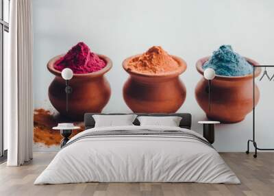 3 small terracotta pots with different colors of holi powder on a white background Wall mural