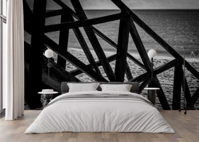 black and white wooden structure over the sea Wall mural